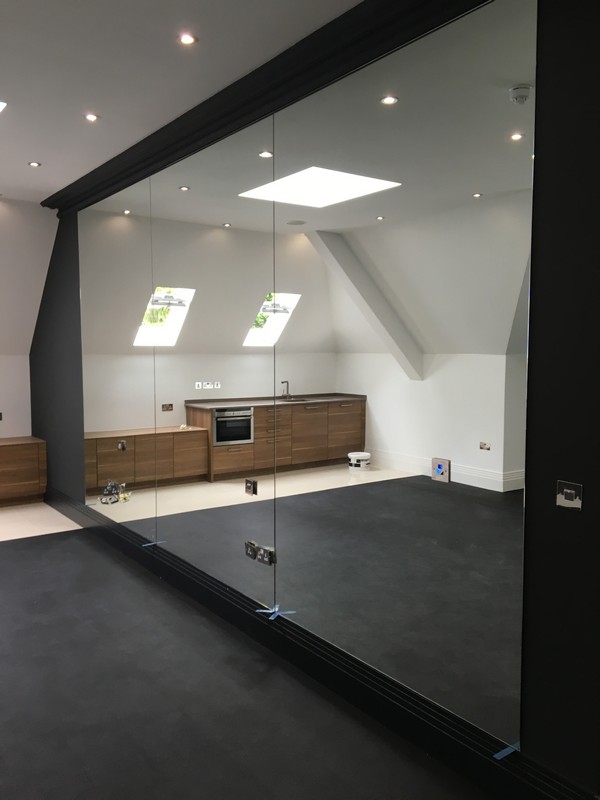Frameless glass partition in loft conversion by Rickmansworth glaziers