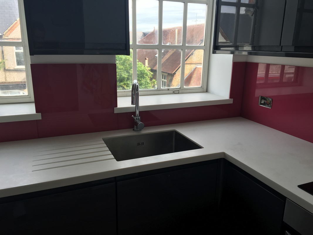 Deep plum coloured glass splashback in modern Rickmansworth kitchen